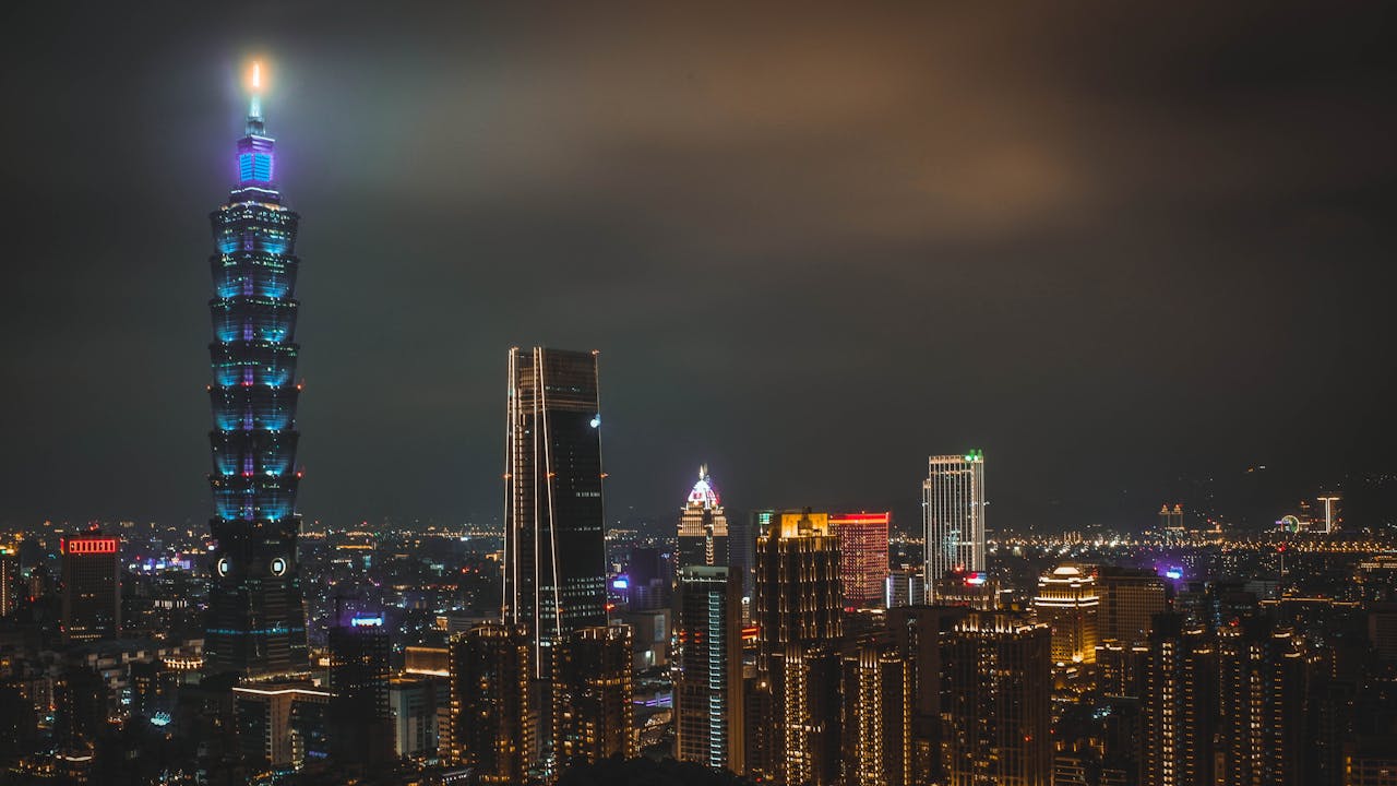 services-02 Night cityscape featuring the illuminated Taipei 101 tower and surrounding skyline in Taipei, Taiwan.